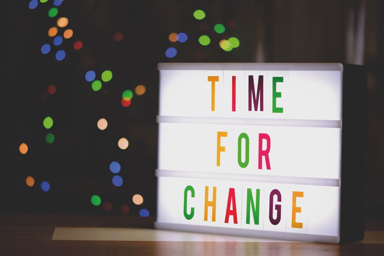 Crafting Captivating Headlines: Your awesome post title goes here Colorful illuminated sign displaying the motivational message 'Time for Change'.